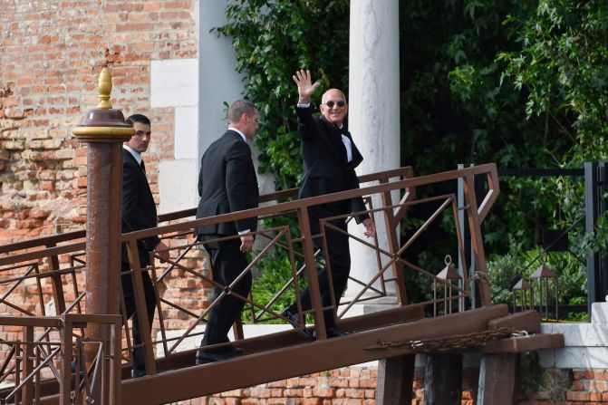 Bezos waves as he arrives at San Giorgio Maggiore on Friday.