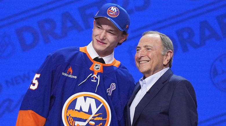 Matthew Schaefer, left, stands with NHL commissioner Gary Bettman after being drafted by the New York Islanders during the NHL hockey draft Friday, June 27, 2025, in Los Angeles. (AP Photo/Damian Dovarganes)
