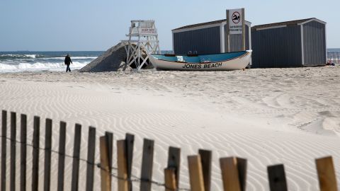 A person walks by the water at Jones Beach in Wantagh, New York, on May 21, 2020.