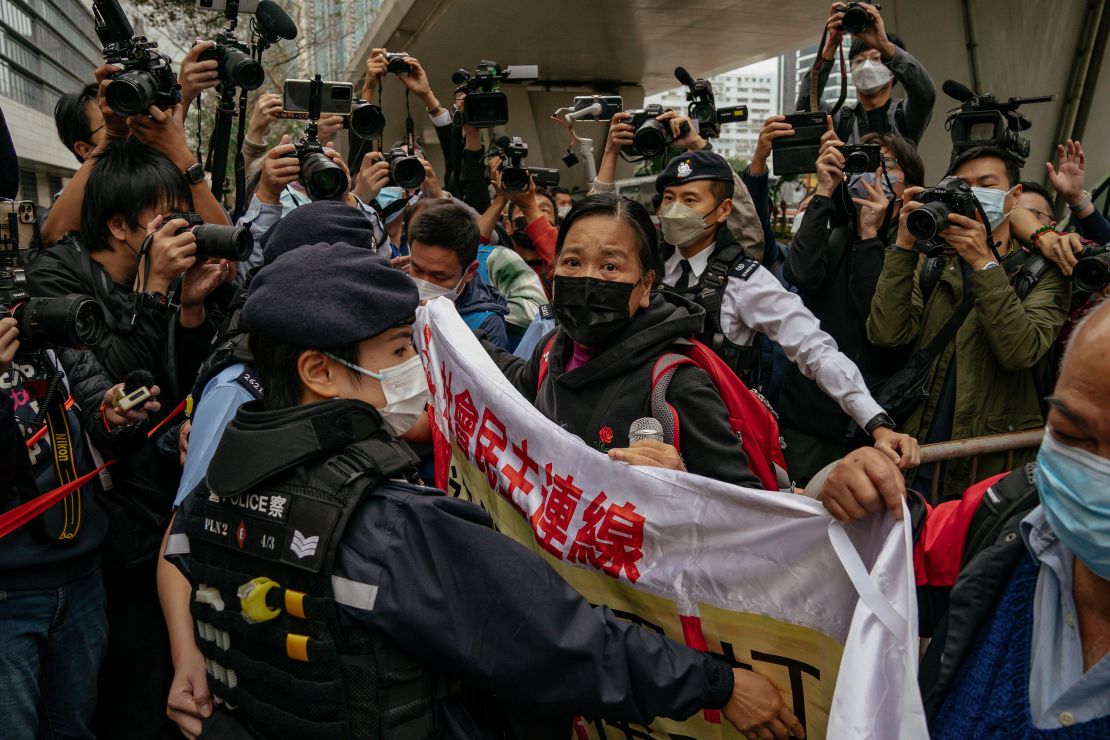 Members of the League of Social Democrats scuffle with police outside the West Kowloon Magistrates' Courts ahead of a national security trial for pro-democracy activists in Hong Kong on February 6, 2023.