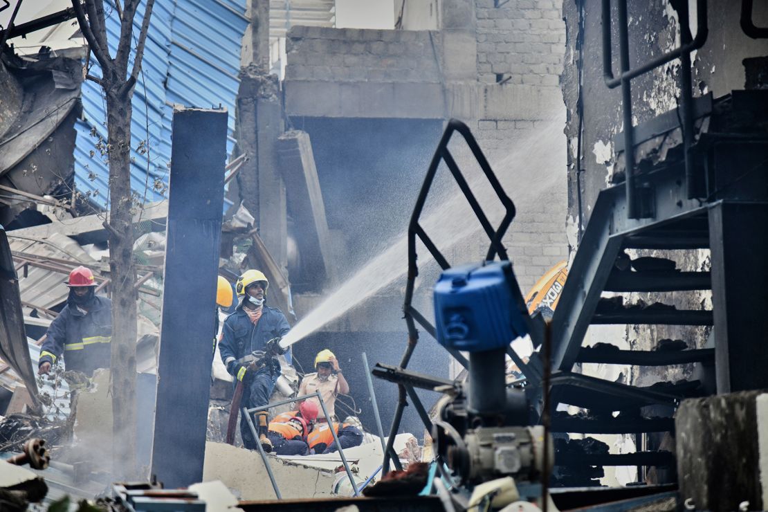 Firefighters extinguish a fire after the explosion and fire at Sigachi Industries’ SIGC.NS chemical factory in southern India.
