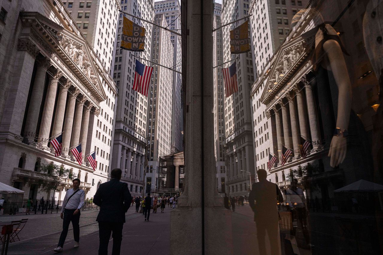 A reflection of a window shows the New York Stock Exchange on June 30.