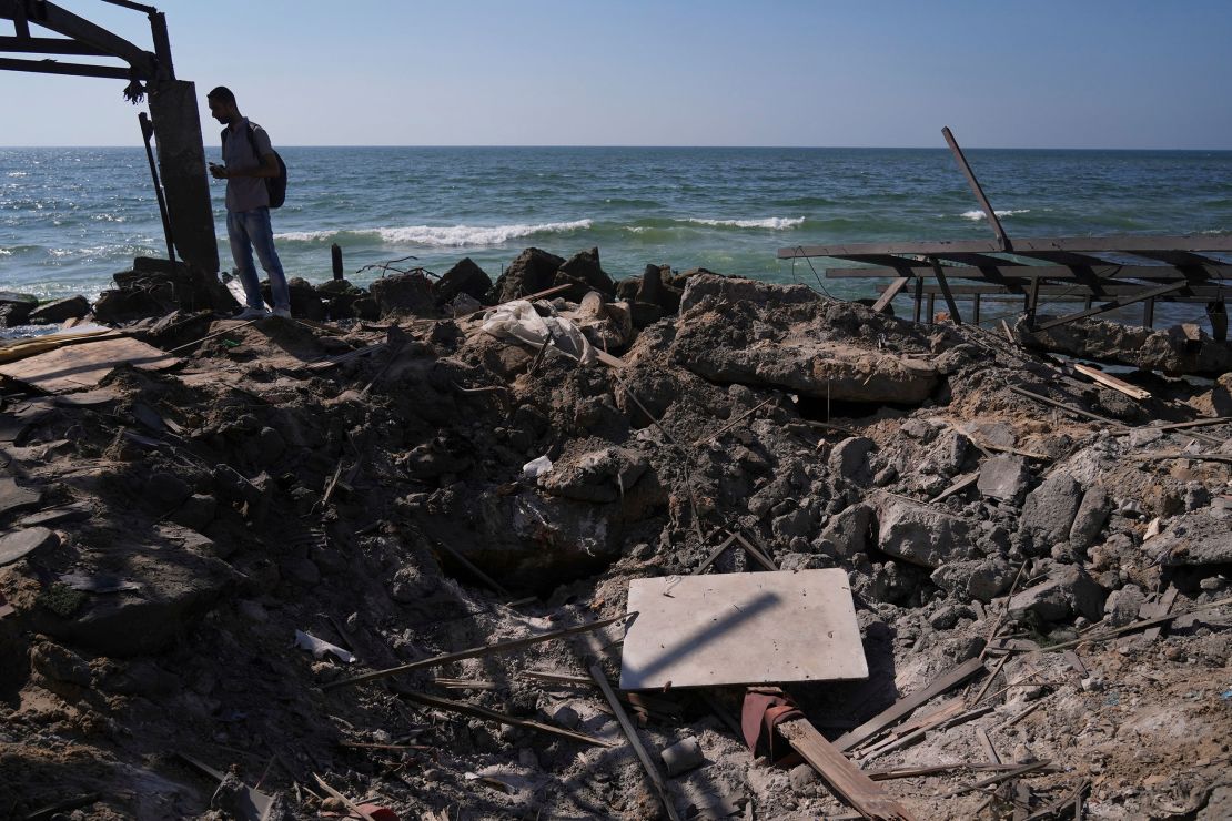 A Palestinian man checks an area near the cafe that was damaged in an Israeli strike on Monday.