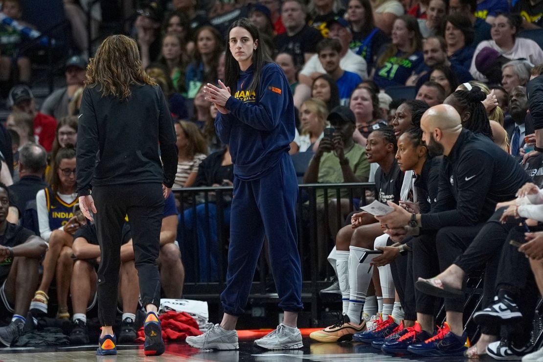Injured Indiana Fever guard Caitlin Clark watches the final from the sideline.