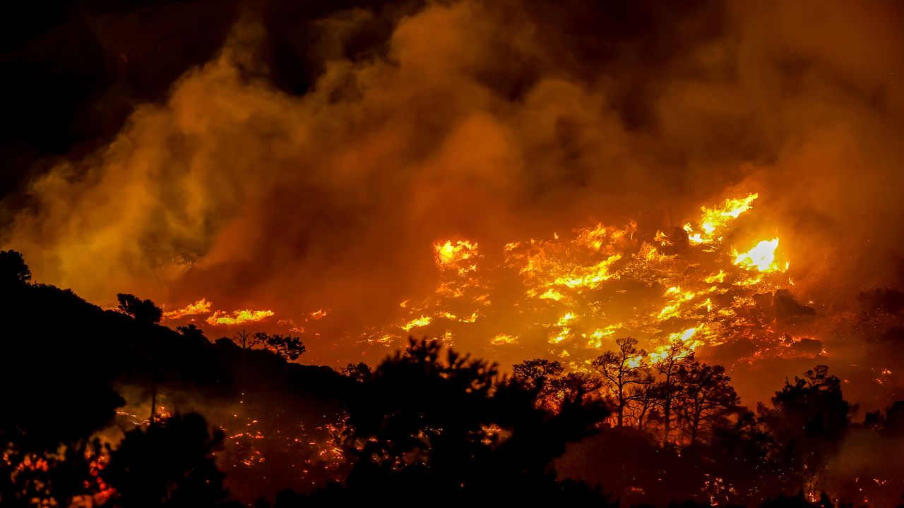 Fire burns in the Ahlia area near the port town of Ierapetra on the south coast of Crete island, Greece, late Wednesday, July 2, 2025, prompting the evacuation of villages and hotels in the region, authorities said.