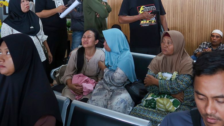 A passenger's relative weeps after a ferry carrying dozens of passengers sank near the resort island of Bali, at Ketapang Port in Bayuwangi, East Java, Indonesia, on Thursday, July 3, 2025.