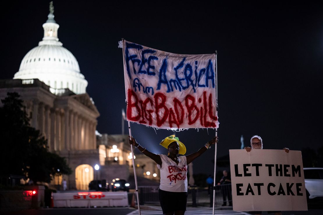 Protesters are seen outside the US Capitol building as the House held a procedural vote on the bill, early Thursday morning.
