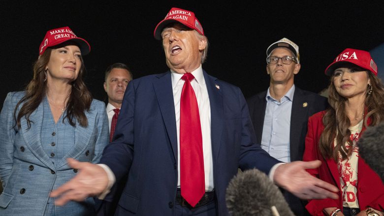 President Donald Trump, center, speaks with reporters as, from left, Agriculture Secretary Brooke Rollins, Rep. Zachary Nunn, R-Iowa, Rep. Randy Feenstra, R-Iowa, and Homeland Security Secretary Kristi Noem listen as they arrive on Friday, July 4, 2025, at Joint Base Andrews, Md. (AP Photo/Alex Brandon)