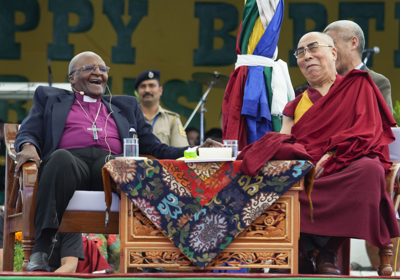 Retired Archbishop Desmond Tutu and Tibetan spiritual leader the Dalai Lama share a lighter moment at the Tibetan Children's Village School in Dharamshala, India, on April 2015.