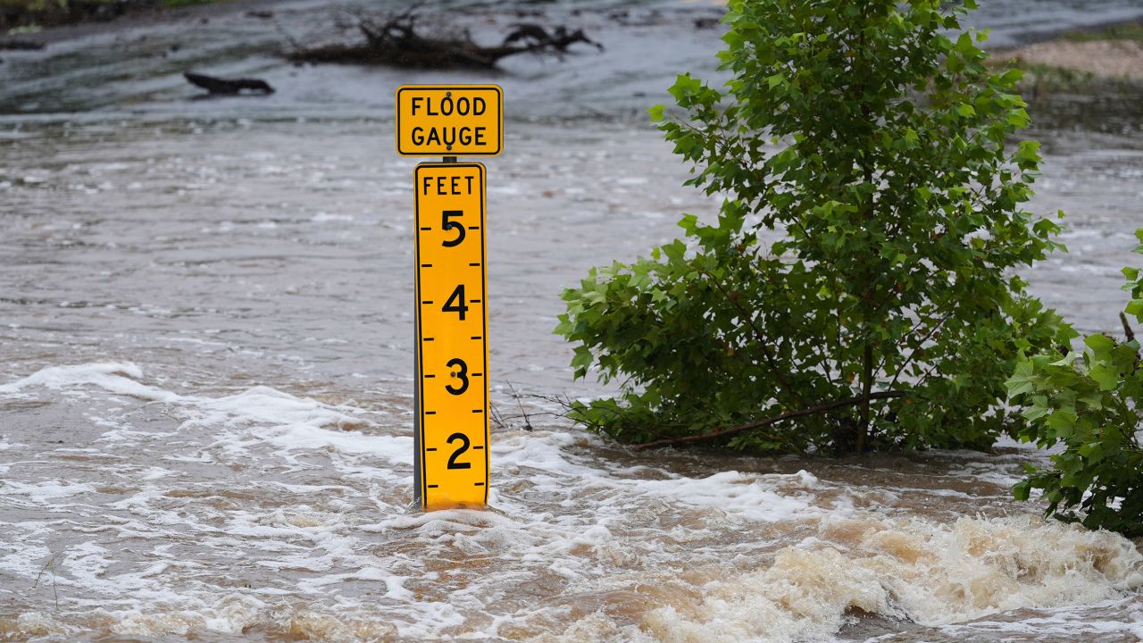 A flood gauge marks the height of water flowing over a farm-to-market road near Kerrville, Texas, on Friday, July 4, 2025. (AP Photo/Eric Gay)