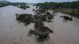 A flooding Guadalupe River, seen in Kerrville, Texas, leaves fallen trees and debris in its wake on Friday, July 4.