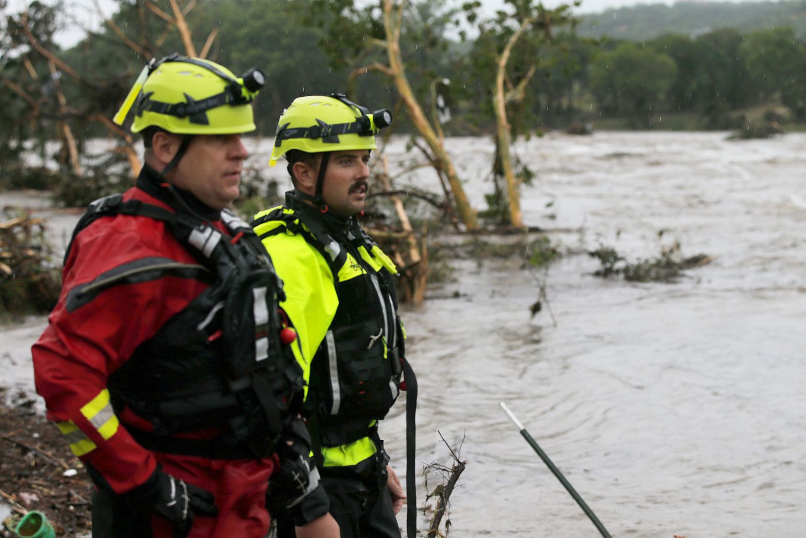 Kerrville Fire Department first responders scan the banks of the Guadalupe River in Ingram.