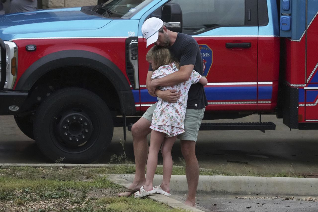 People hug at a reunification center in Ingram.