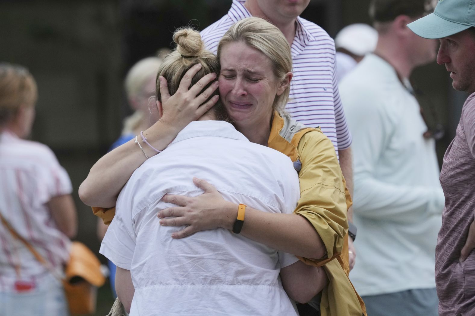 Families hug at a reunification center in Ingram, Texas, after flash flooding hit the area on Friday.