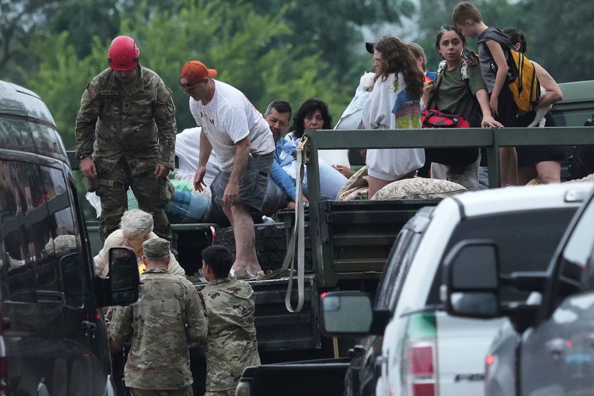First responders deliver people to a reunification center in Ingram on Friday.