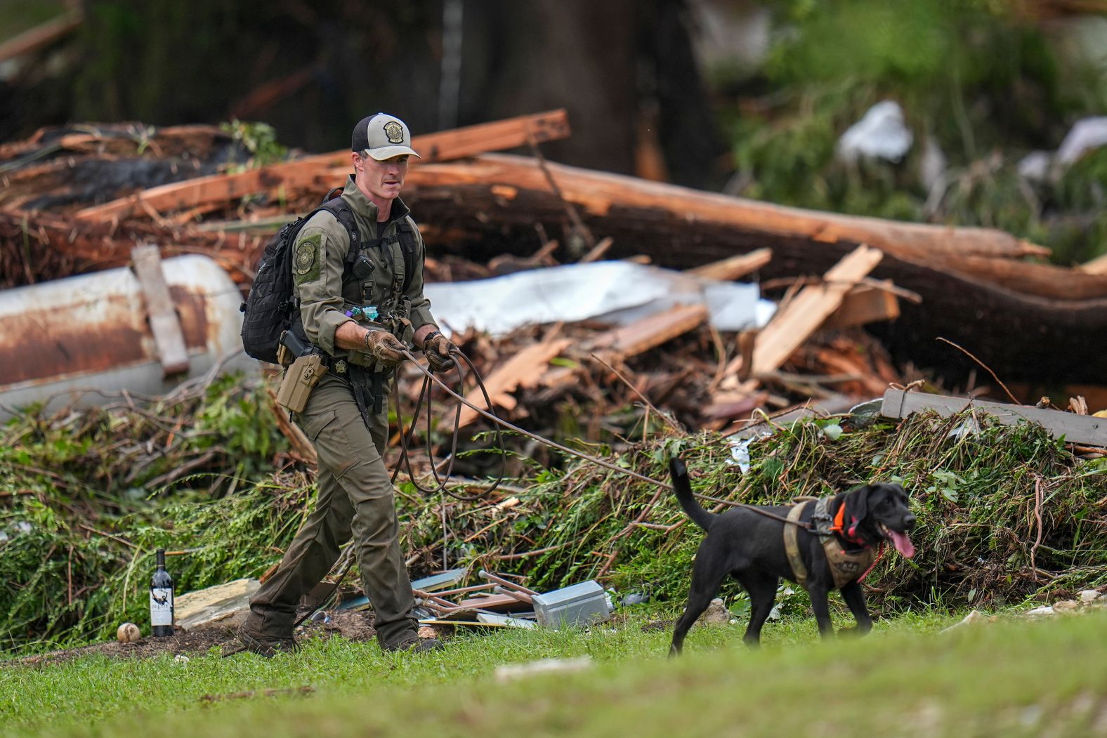 Officials comb through the banks of the Guadalupe River in Hunt.