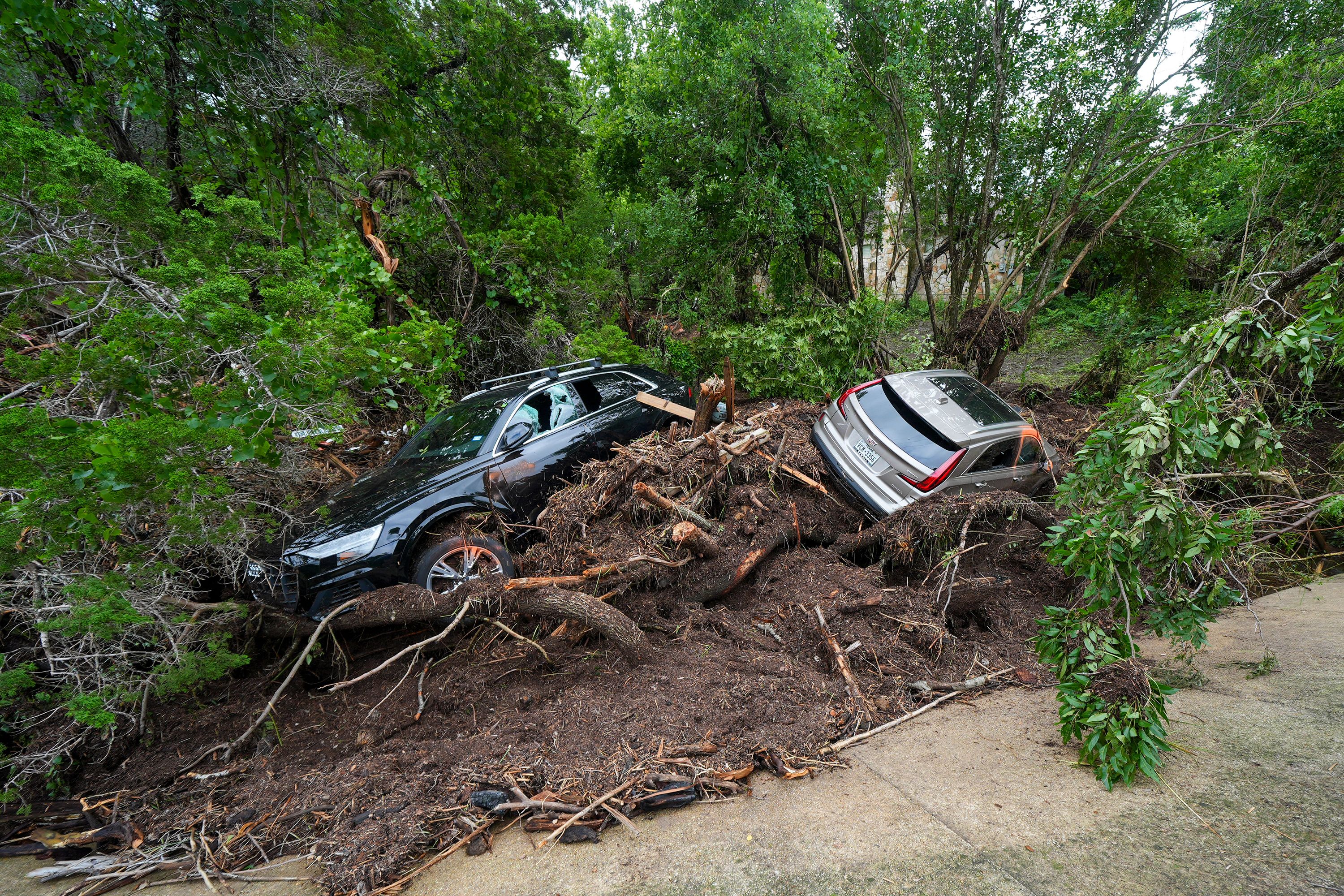 Vehicles lay amongst debris after being washed away by floodwaters in Hunt.