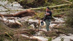 A Sheriff's deputy pauses while combing through the banks of the Guadalupe River near Camp Mystic, Saturday, July 5, 2025, in Hunt, Texas, after a flash flood swept through the area.