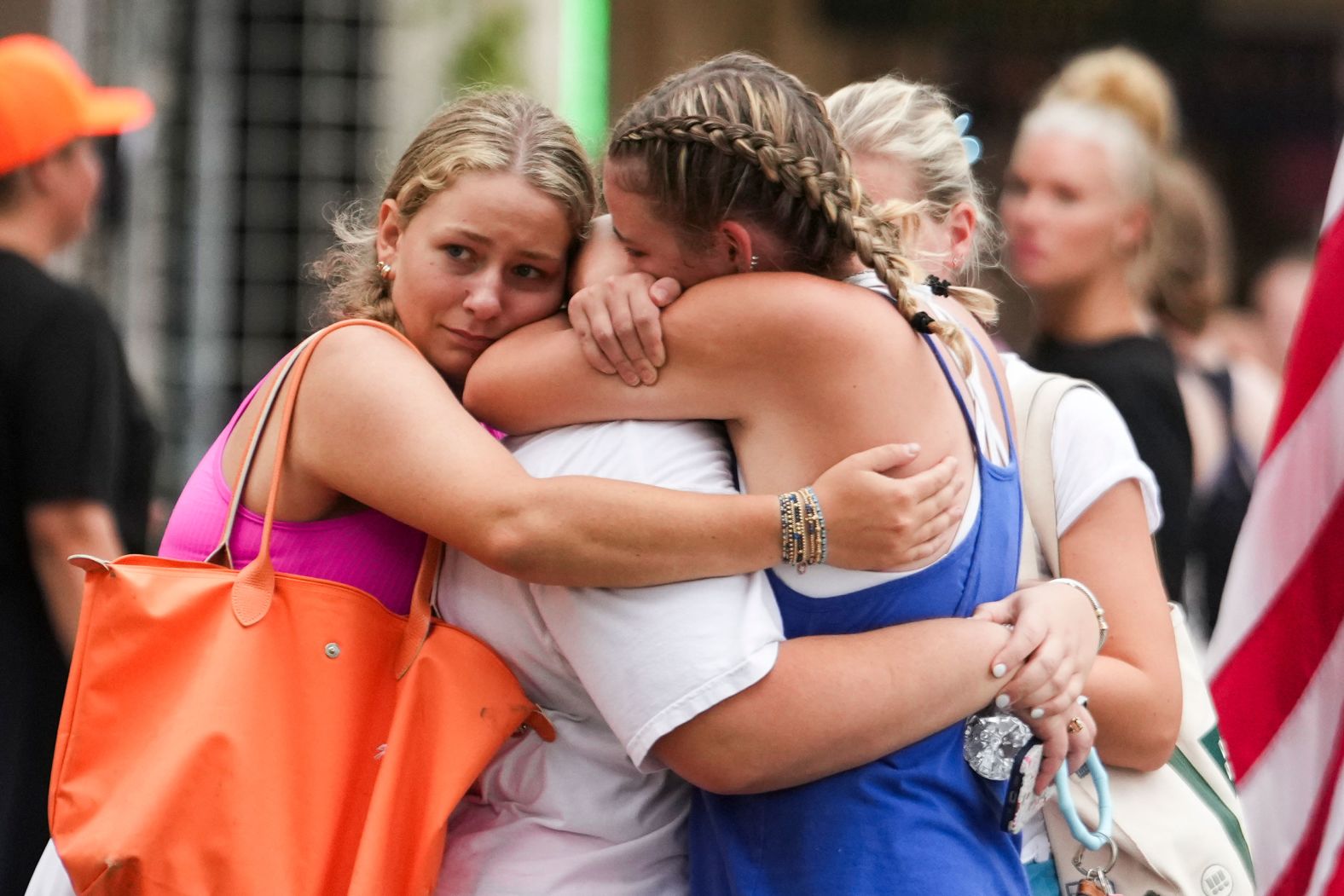 Campers embrace at a reunification area as girls from Camp Waldemar, near the north fork of the Guadalupe River, are reconnected with their families on Saturday.