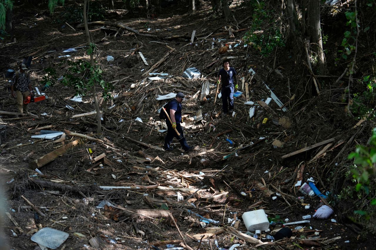 Members of the Kerrville Fire Department search through debris in Kerrville, Texas, on Tuesday.