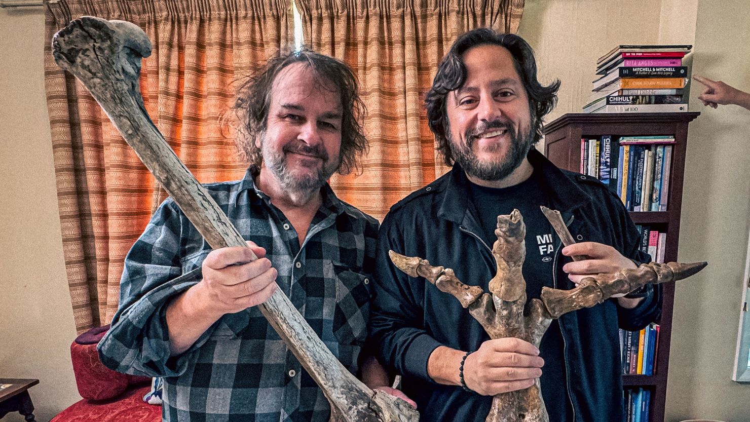 Filmmaker Peter Jackson, left, and Colossal CEO Ben Lamm hold up bones from Jackson's collection of extinct moa bones in Wellington, New Zealand in 2024.