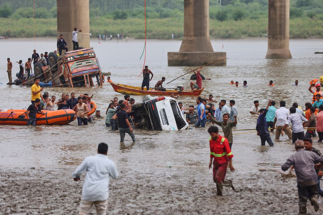 Rescuers and locals look for survivors.