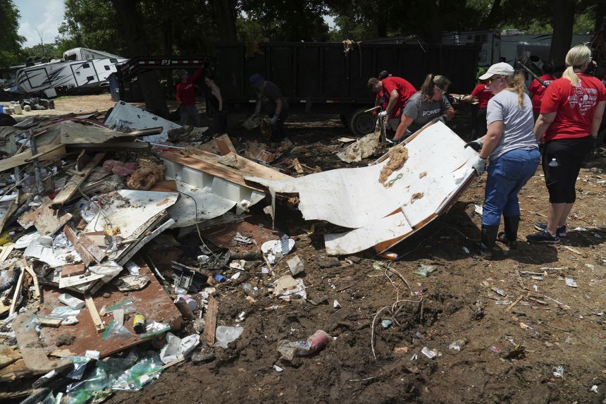 Crews remove flood debris at an RV park in Georgetown, Texas.
