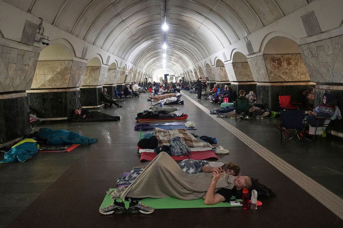 People rest in a metro station that is being used as a bomb shelter, in Kyiv on Thursday morning.