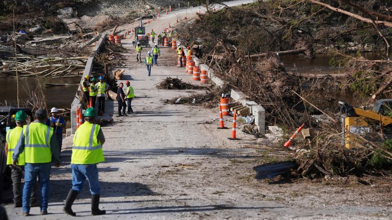 Crews work to clear debris July 10 on the Cade Loop Bridge after flooding along the Guadalupe River in Ingram, Texas.