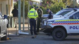 Police officers gather in Beacon, Western Australia, Friday, July 11, 2025, as they prepare to search for missing German backpacker Carolina Wilga. (ABC News via AP)