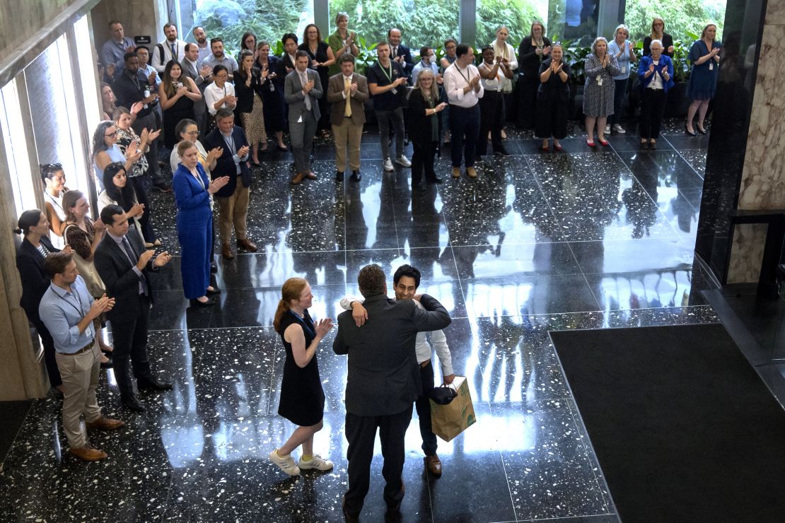 State Department employees applaud as their colleagues walk through the lobby of the State Department headquarters in the Harry S Truman Building, Friday, July 11, 2025, in Washington.