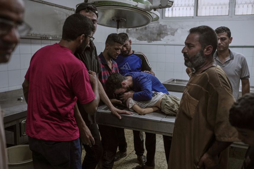 Palestinians mourn a child killed by an Israeli airstrike, at the morgue of Al-Shifa Hospital, Gaza City, on July 12. More than 50,000 children have been killed or injured, according to the UN.