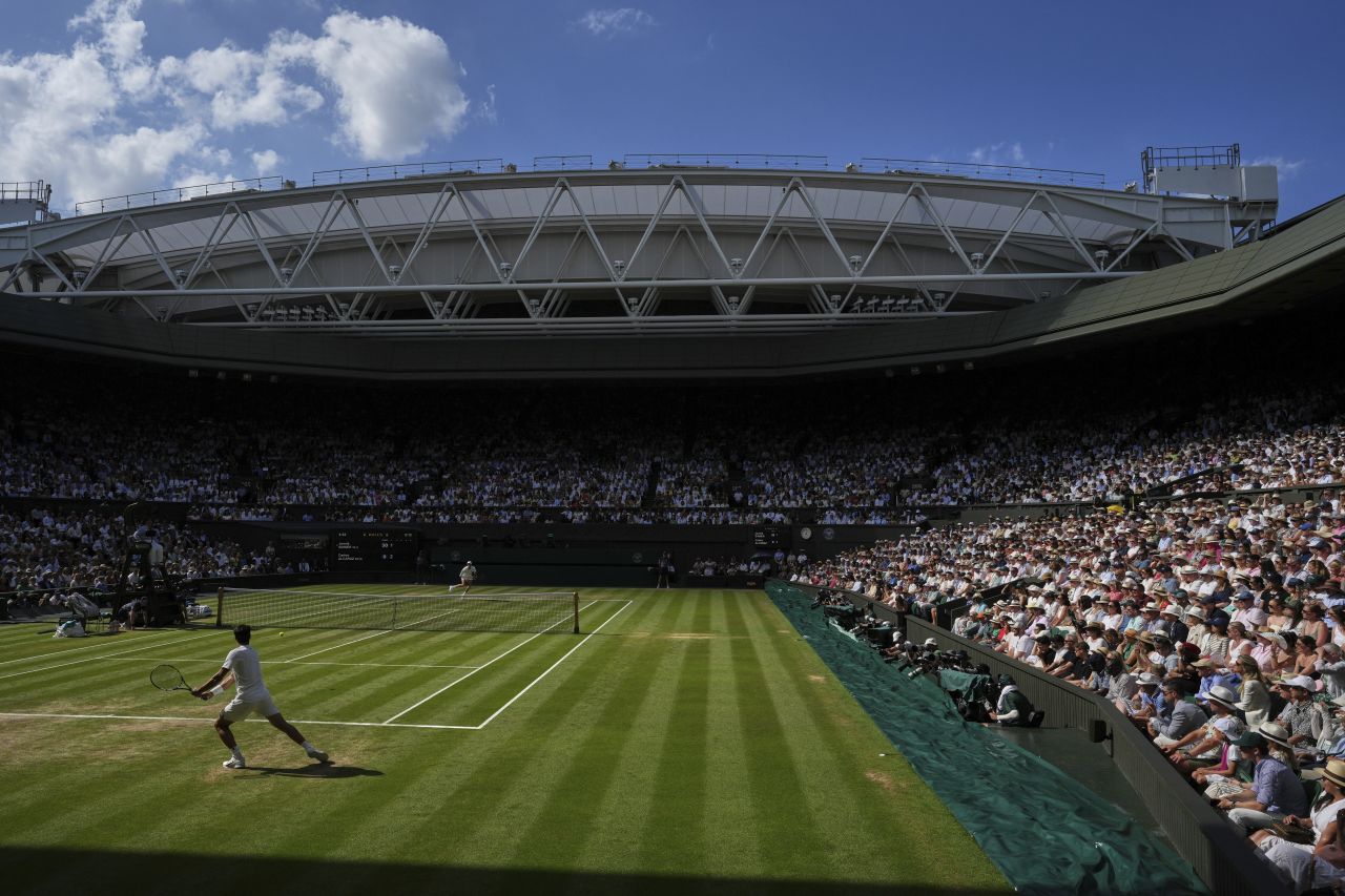 Carlos Alcaraz, foreground, competes against Sinner on Centre Court.