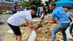 Volunteers fill sandbags for New Orleans residents, Wednesday, July 16, 2025, anticipating heavy rain from a tropical weather system moving toward the Gulf Coast.