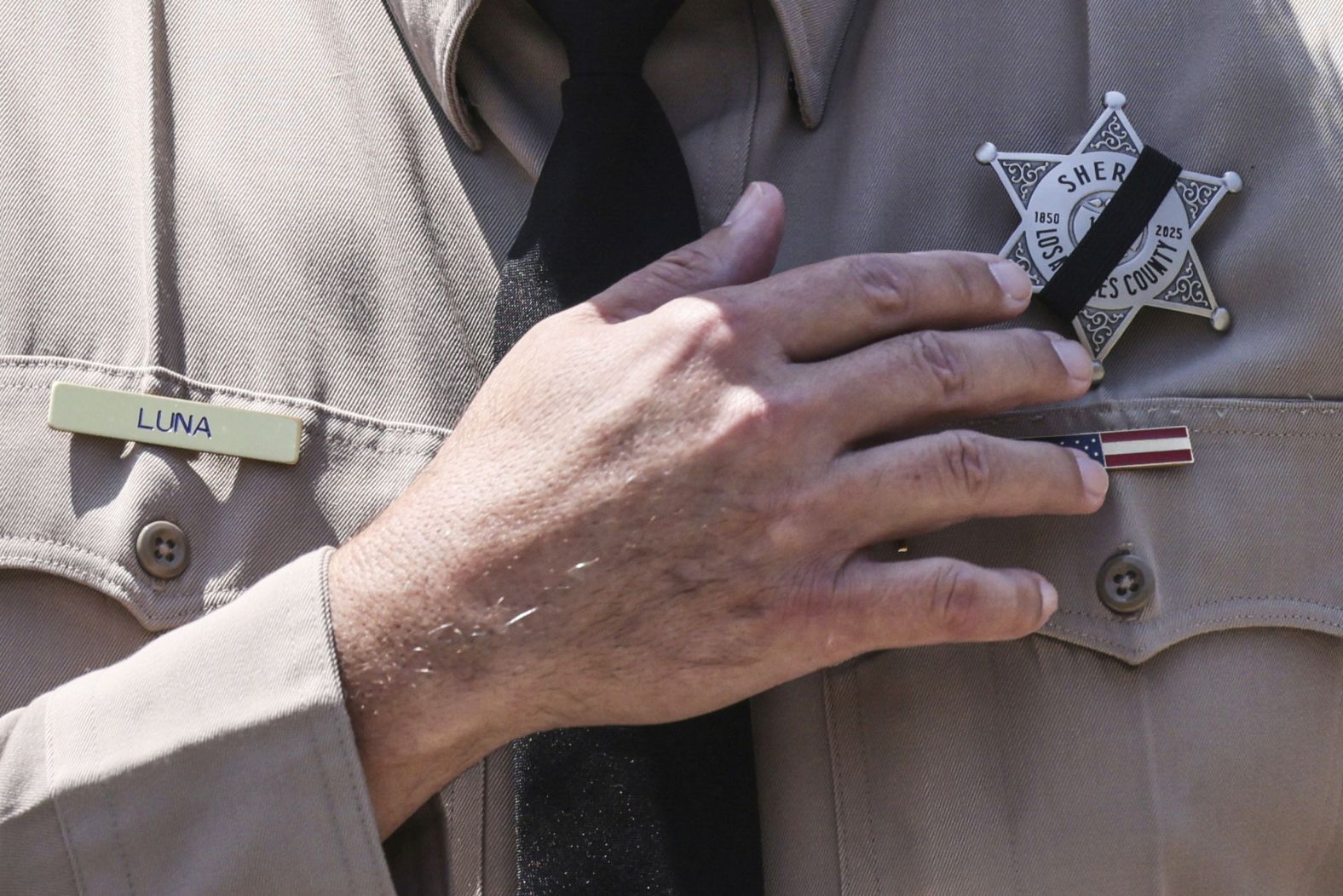 Los Angeles County Sheriff Robert Luna wears a band over his badge after three members of the department <a href="index.php?page=&url=https%3A%2F%2Fwww.cnn.com%2F2025%2F07%2F18%2Fus%2Flasd-facility-explosion-east-los-angeles">were killed in an explosion at a training facility</a> on Friday, July 18. The explosion is believed to have been an accident.