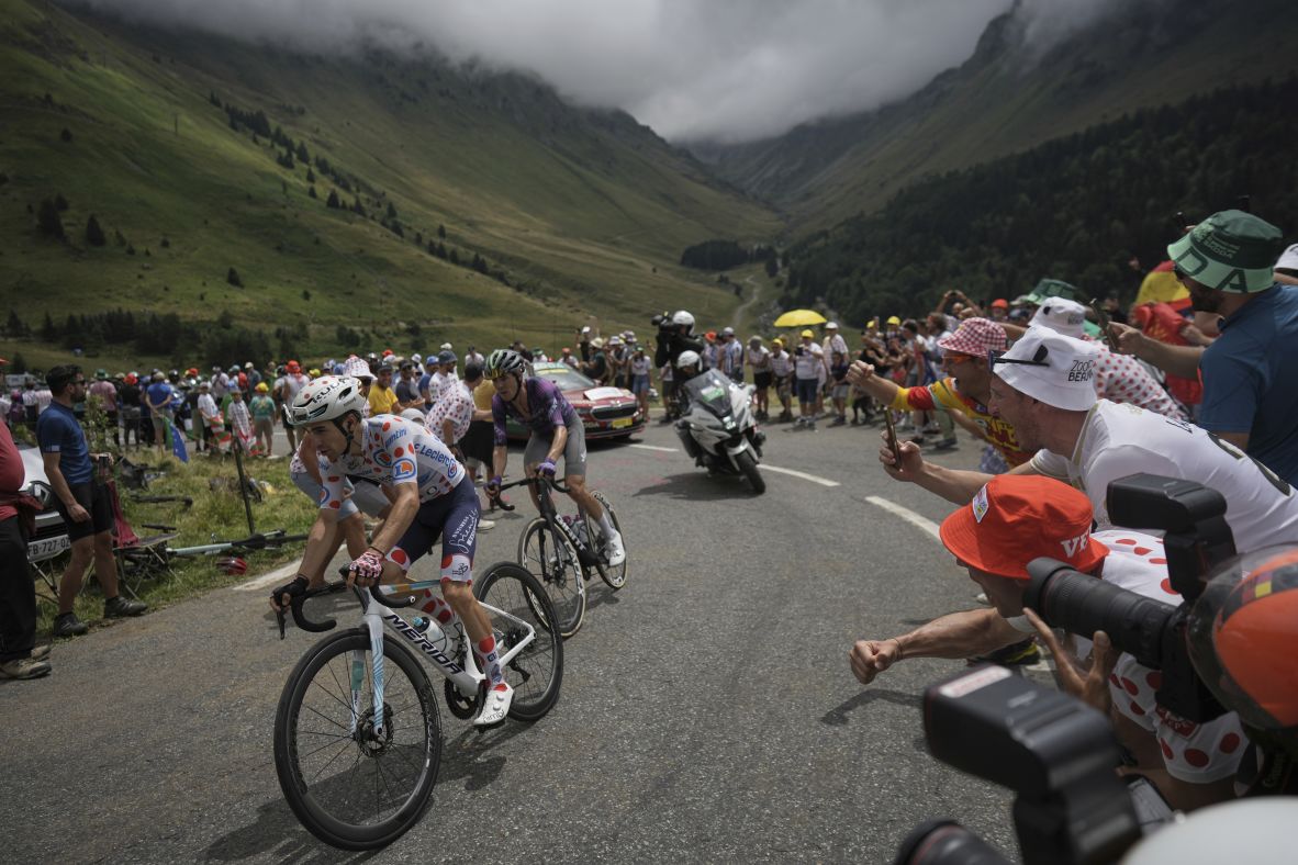Spectators cheer on cyclists during the 14th stage of the Tour de France on Saturday, July 19.