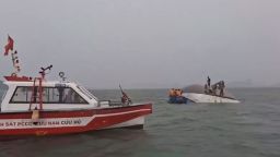 Survivors clung to the capsized tourist boat for hours before being rescued in Ha Long Bay, Vietnam on Saturday.