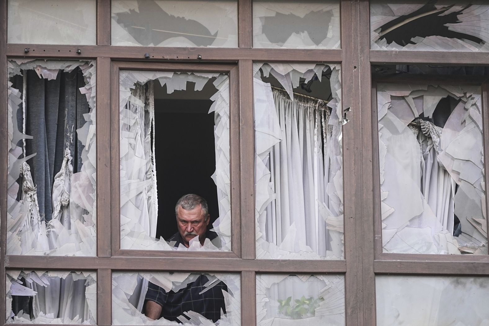 A man stands at the broken windows of his house after a Russian attack in Kyiv, Ukraine, on Monday, July 21. Residents of Kyiv and other major Ukrainian cities faced another sleepless night on Sunday as <a href="index.php?page=&url=https%3A%2F%2Fwww.cnn.com%2Fukraine-drones-moscow-airport-disruptions-intl-hnk">Russia launched 450 missiles and drones</a> overnight into Monday, Ukraine’s Air Force said. The majority were shot down, the Air Force said, but 23 struck across three locations and debris from intercepted missiles landed in 12 areas.