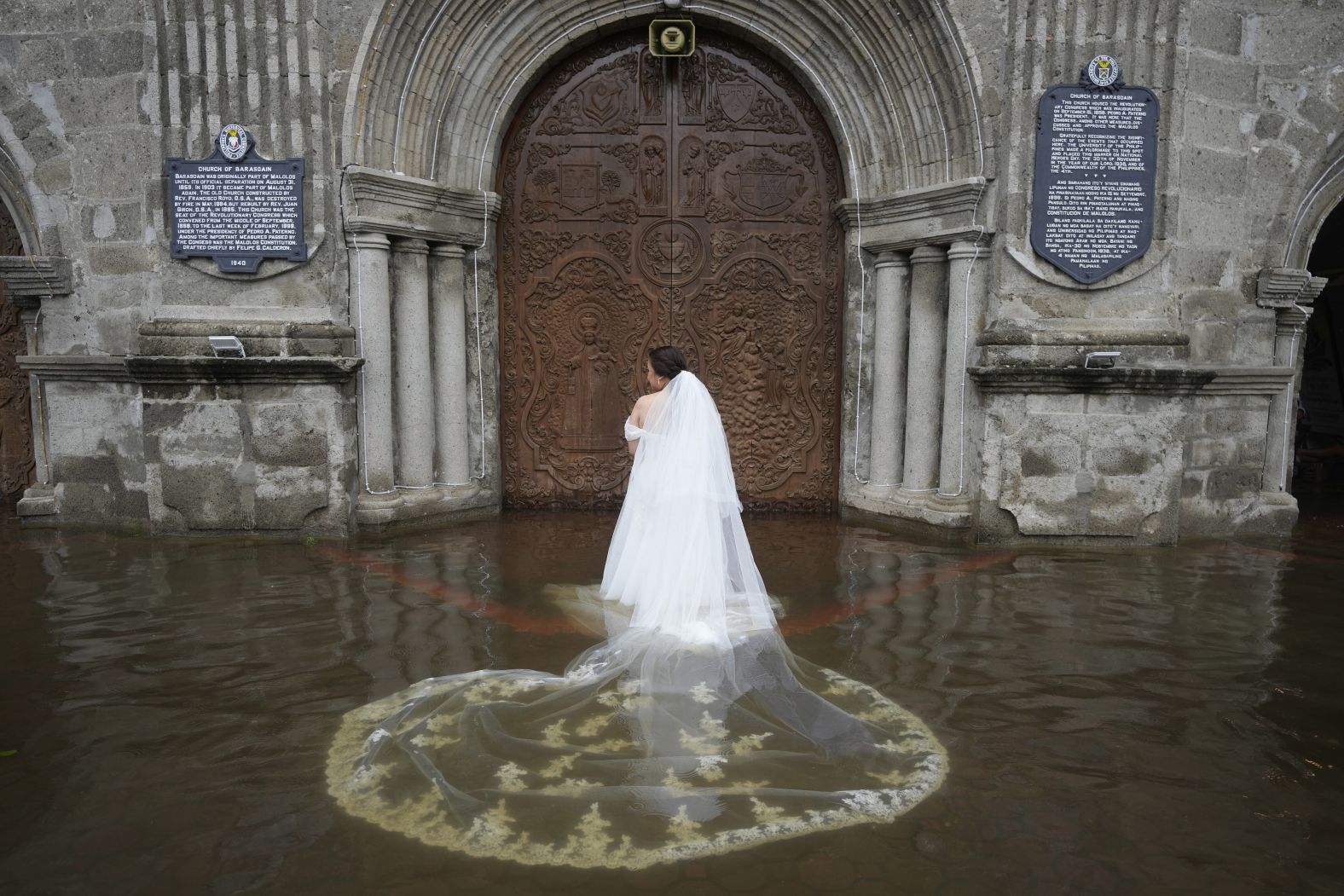 Jamaica Aguilar prepares to enter the flooded Barasoain church for her wedding in Malolos, Philippines, on Tuesday, July 22. The church flooded due to heavy rain from Typhoon Wipha, but she and her fiancé <a href="index.php?page=&url=https%3A%2F%2Fwww.cnn.com%2F2025%2F07%2F23%2Fasia%2Fphilippines-wedding-flood-photos-intl-hnk">pushed through with their wedding anyway</a>.