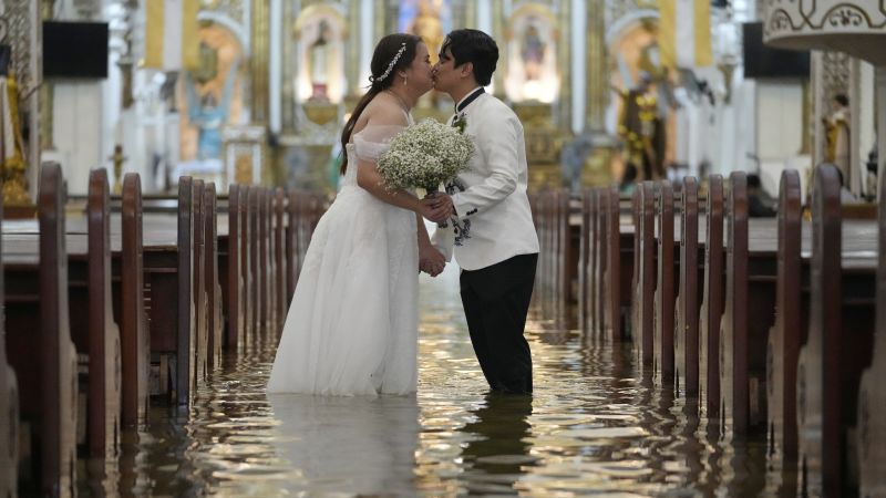 Couple in Philippines ties knot in flooded church during Typhoon Wipha Couple in Philippines ties knot in flooded church during Typhoon Wipha
