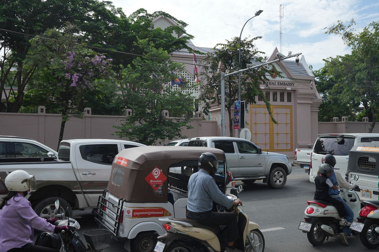 Local vehicles pass the Thai Embassy in Phnom Penh, Cambodia, on Thursday.