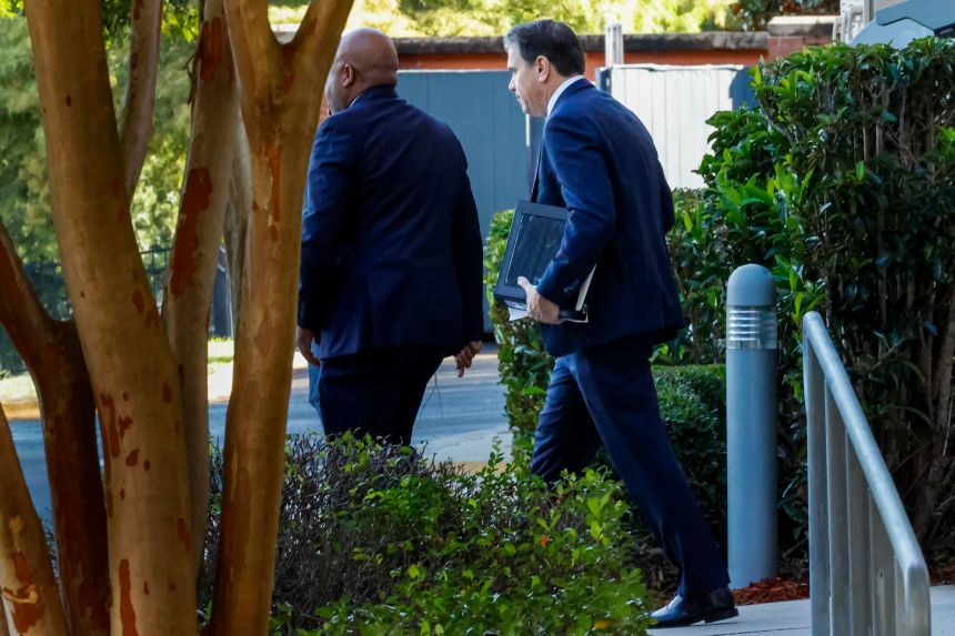 Deputy Attorney General Todd Blanche, right, leaves his hotel for the federal courthouse on Friday in Tallahassee, Florida.