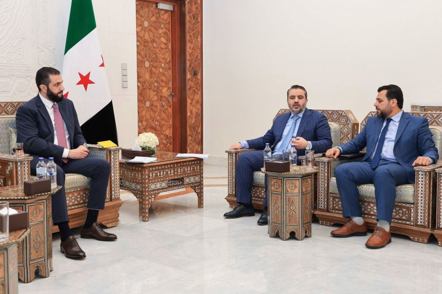 Syria's interim President Ahmad al-Sharaa, left, meets with Syria's Foreign Minister Asaad al-Shibani, center, and Mohammed Taha al-Ahmad, chairman of the Higher Committee for People's Assembly Elections, right, in Damascus, Syria, Sunday, July 27, 2025.