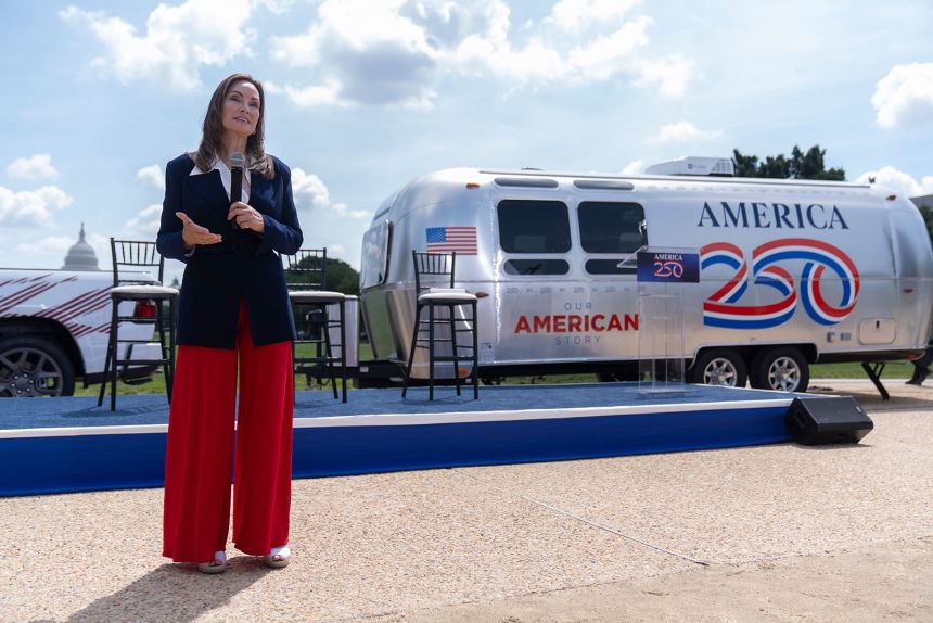 America250 chair Rosie Rios stands near a trailer that will be taken around the country to record oral and visual histories as she speaks during an event to mark the launch of the 