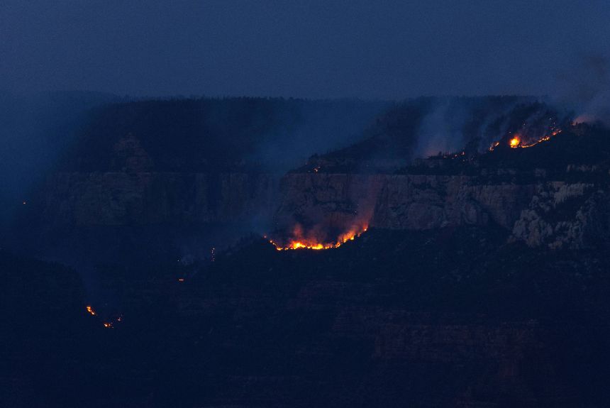 Smoke and flames from the Dragon Bravo Fire are seen at sunset at the Grand Canyon in Arizona on Monday, July 28.