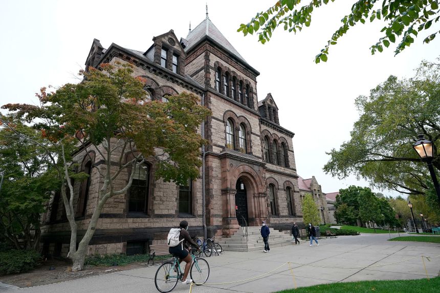 People traverse Brown University campus in Providence, Rhode Island, on October 12, 2020.