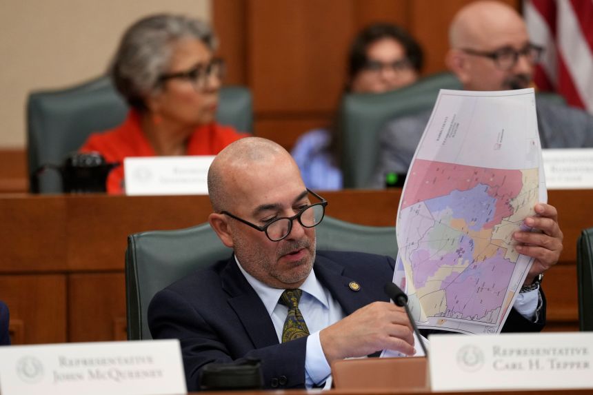 Texas state Rep. Carl H. Tepper looks through maps during a public hearing on congressional redistricting in Austin, Texas, Friday, Aug. 1, 2025.