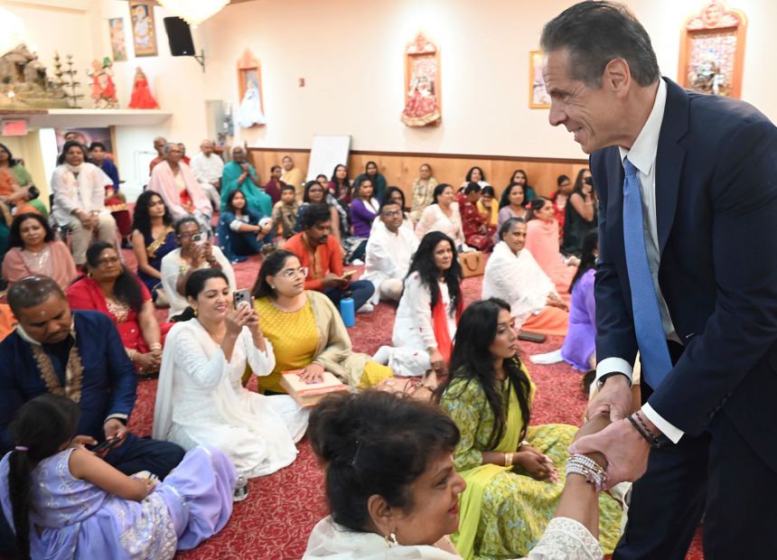 Cuomo shakes hands with congregants at Hindu Temple Bhuvaneshwar Mandir in Ozone Park, Queens, New York, on August 3.