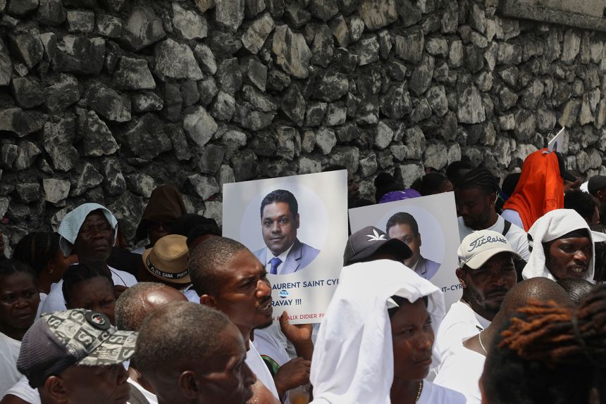 Supporters celebrate the installation of Laurent Saint-Cyr, who replaces Fritz Alphonse Jean, in the rotating presidency of the transitional presidential council in Port-au-Prince, Haiti, Thursday, Aug. 7, 2025. (AP Photo/Odelyn Joseph)