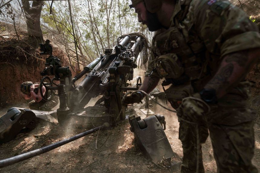 Ukrainian servicemen fire a M777 howitzer towards Russian positions at the frontline in Ukraine's Zaporizhzhia region on Thursday.